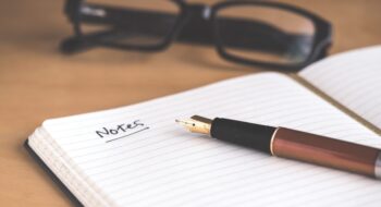 brown fountain pen on notebook